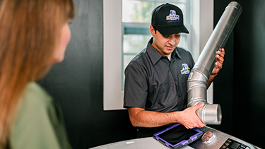 Dryer Vent Wizard tech showing vent to customer.